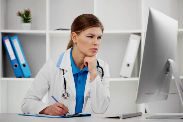Doctor performing grading an Online Medical Evaluation